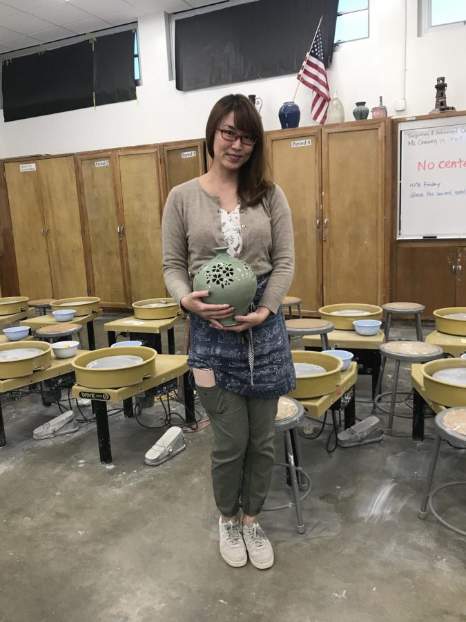 Ms. Cheung with a vase she made.