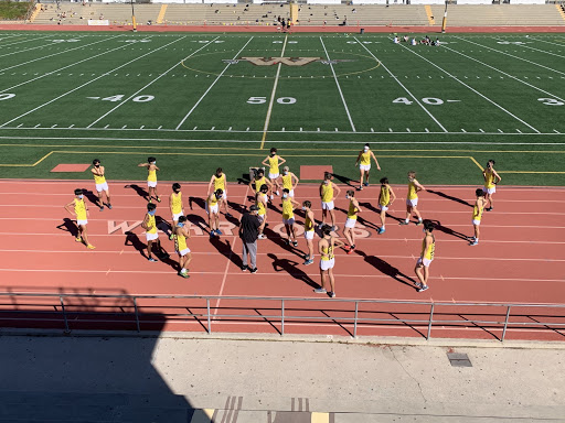 West High’s Boys’ Cross Country athletes gather on the track of Fred Peterson Football Stadium on the morning of February 20, listening as Coach Druten speaks. Masked and distanced, the team prepares for their first race against El Segundo High, kicking off the 2021 season.