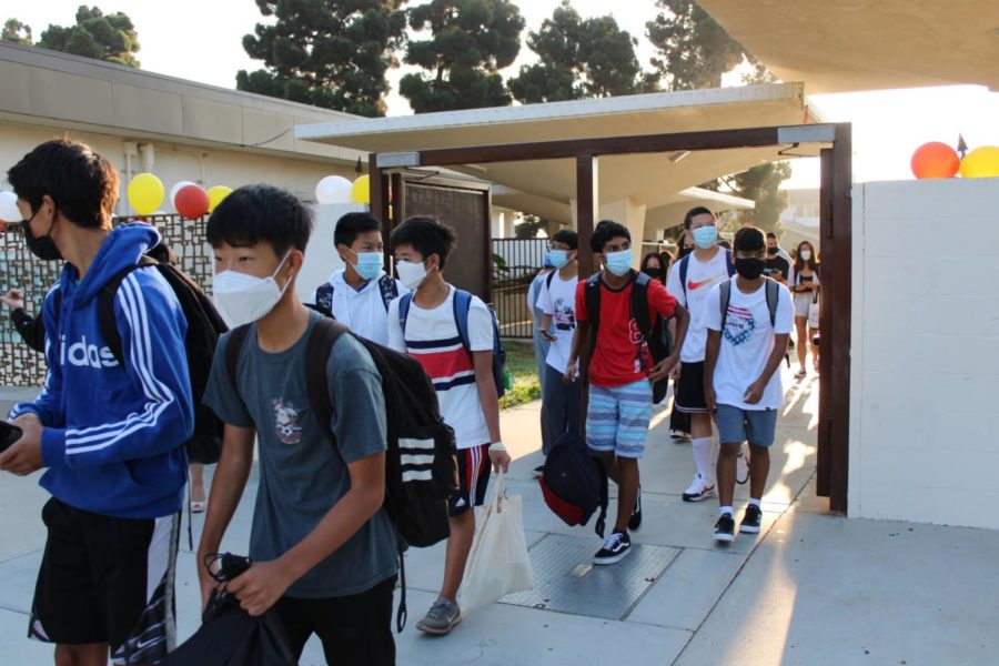 Students make their way through the gates of West High School on their first day of class, wearing masks and presenting their cleared COVID-19 screeners. Photo courtesy of Gaby Nieraeth (11).