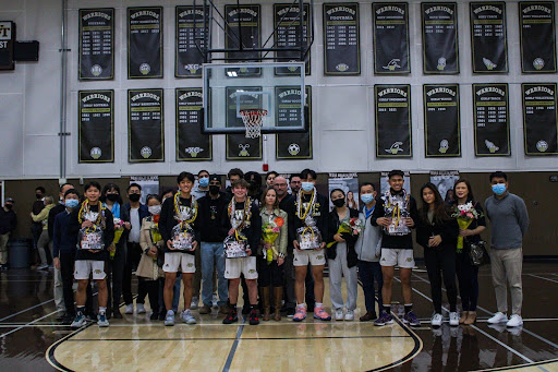 All five seniors on the Boys’ Basketball team hold gift packages and wear leis around their necks. Around them are their parents, coaches, and loved ones, celebrating the day that the boys had been working up to for the past four years. Matthew De Luna (11) of the Varsity team commented “They’ve worked so hard the whole time they’ve been with the program and it was their night.”