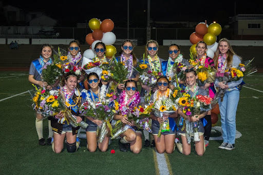 Seniors celebrate their win against North High on their Senior Night. “They’ve taught us a lot about how to be a team and supporting everyone,” Lucy Hasenmayer (10) commented. Seniors played their last game of the Pioneer League and were undefeated all season.