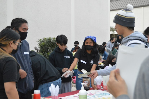 Students promote their clubs and sell food at West High’s Night Market. This was an opportunity to introduce incoming freshmen to what their high school experience may be like and was an exciting event for all current students. “The night may have even been over successful,” Shelly Maekawa (12) said, laughing. Photo by Kayla Dadivas (11). 
