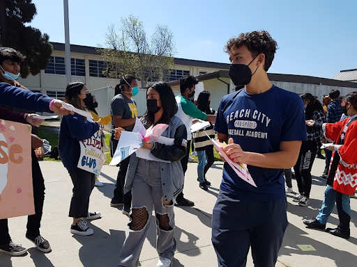 Current eighth graders collect flyers from different clubs at Club Alley after coming out of the eighth grade assembly.