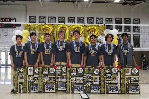 Seniors from the volleyball team wear celebratory leis on their shoulders with posters in hand. Players celebrated their win as they walked down a line and posed for photos with loved ones. “I’m grateful for the time we’ve had together,” said senior Jason Irie. 
