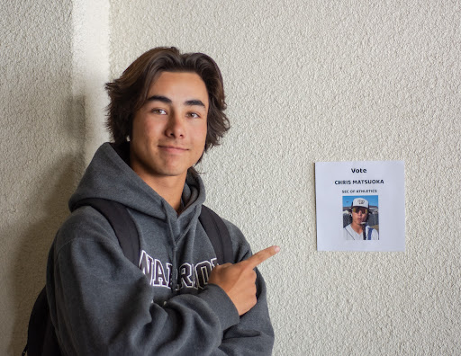 Chris Matsuoka (11), a candidate for Secretary of Athletics, is hanging up posters for his campaign. As an athlete himself in baseball, Matsuoka hoped to “get as much hype as possible for our student section and to represent all of our athletes,” if he was elected.