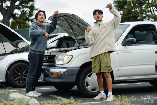 Christopher Matsuoka (11) and his friend Ben Arrata (11) stand next to his 1998 Toyota Tacoma. “My favorite thing about my car is how none of my friends can drive it, being a manual,” Matsuoka said proudly. “I guess it’s a part of who I am now. Its always there and I’m always fixing it.” 
