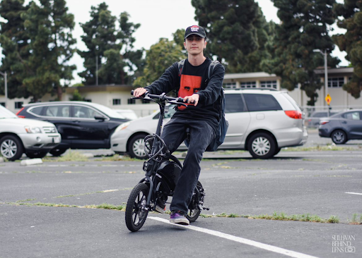 Riding his Jetson e-bike through the West High parking lot, Ali Zarenezhad (12) showcases one of the centurys coolest inventions. No matter size, shape, or engine, the West High parking lot has it all. 
