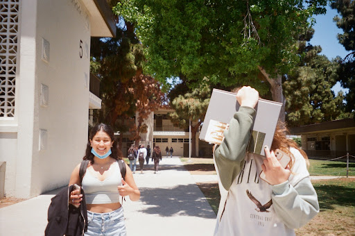 Enjoying a stroll by building 5 during lunch, Lily Le (12) and Kiera Strader (11) skim through the yearbook. “I’m sad the seniors are leaving, especially Lily because she is one of my best friends . . . this year sure went by fast,” Strader expressed. Such a bittersweet week for sure, but the memories shared among friends will last forever. 
