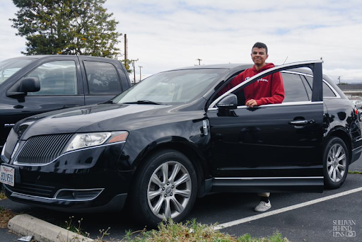 Entering his car, George Abdou (11) shows off the stereo to his friends. “My favorite thing about my car is how many friends I can fit in it . . . Also, it has the 2016 Lincoln Mkt Ecoboost so its fast for its size. Driving it just makes me happy.” 
