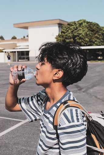 A West High student, Adrian Lopez Castillo (10), drinks water to stay hydrated in the scorching and displeasing weather. Lopez Castillo expressed his thoughts on the weather: “This hot weather has definitely been hard to get used to over the past week or two, and I hope we go back to our normal temperatures soon.” With the lack of air conditioning and ways to stay cool at school, many other students have started to feel the same.
