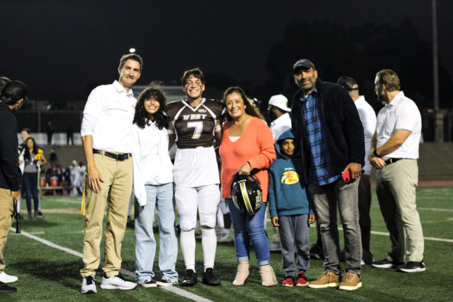 Wide receiver and cornerback Ernesto Hernandez (12) and family.