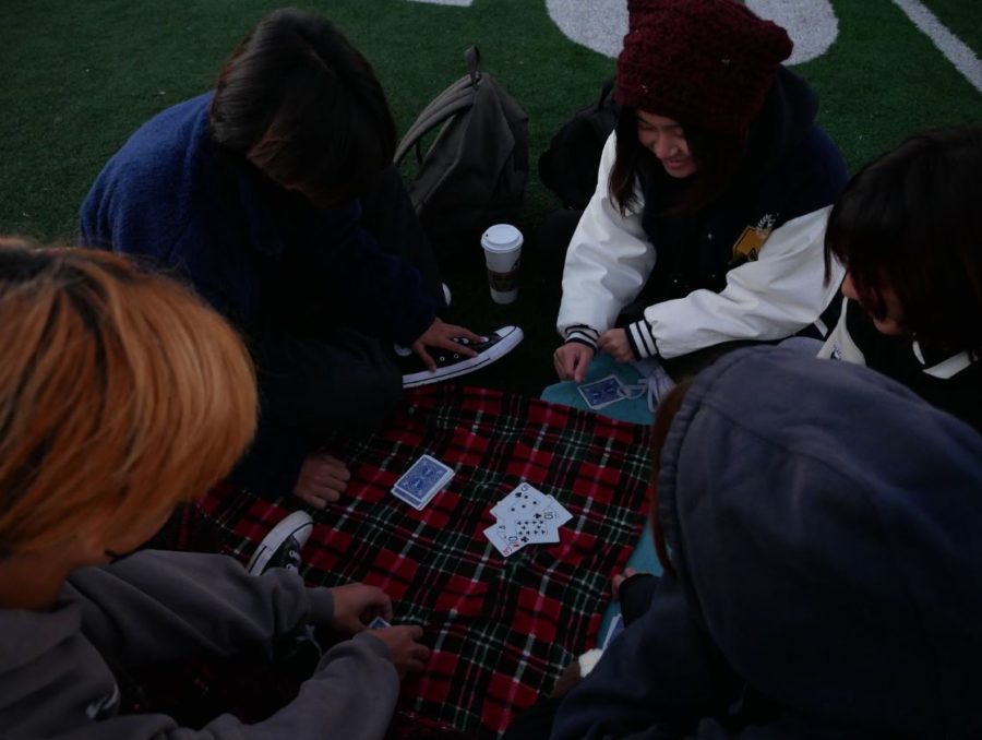 Yudai Shimizu (12), Kevin Han (12), Marina Soen (12), Elise Fauni (12), and Rakza Srivanitchayakun (12) enjoy themselves by playing an intense game of cards.