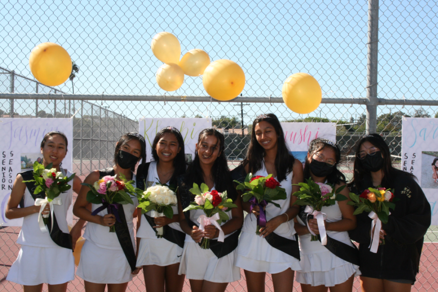 The seniors of West High’s Girls Tennis team smile after a spectacular victory against North High — with a 14-4 win against the Saxons, the players ended senior night on the highest note possible. The colorful balloons and handcrafted posters served as a reminder of their teammates’ faith and support for them as they continued to open a new chapter in their high school careers. Pictured from left to right: Aki Sugita (12), Alexssa Takeda (12), Jasmin Cuaresma (12), Khushi Sharma (12), Arushi Bagchi (12), Sarah Han (12), Samantha Takeda (12). Photo courtesy of Taeyi Ko (11).