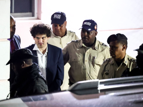 Crypto mogul Samuel Bankman-Fried is escorted from a courthouse by Bahamian authorities after his arrest in Nassau, Bahamas. Following his extradition to the United States, Bankman-Fried was bailed out by his parents for $250 million, one of the largest bails in history. Commenting on this move, West High student Benjamin Choi (12) remarked that “I think [Bankman-Fried] should be held more accountable for [his crimes],” agreeing that nominal bail for the ultra-wealthy encourages apathy and equates to a slap on the wrist. Photo courtesy of Reuters.
