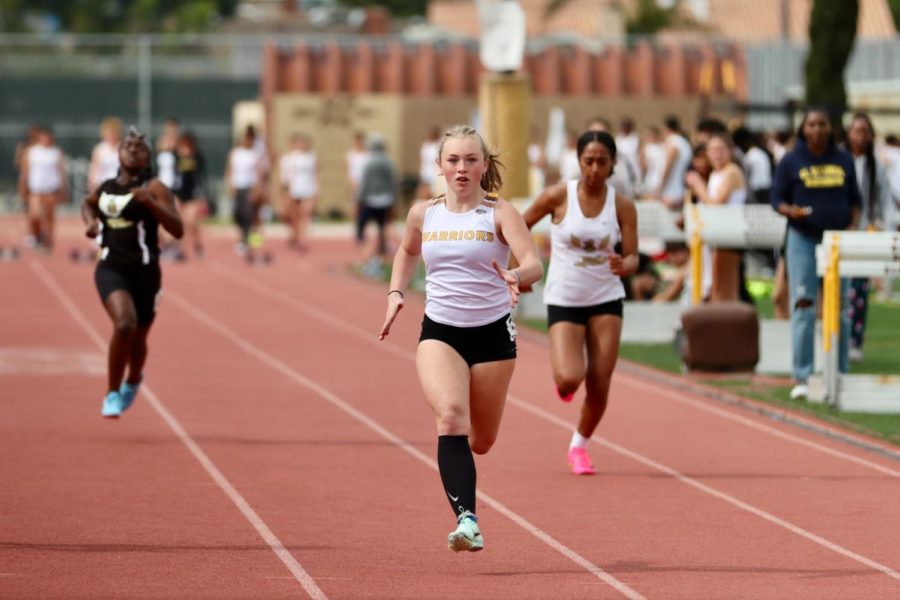 Blazing+down+her+lane%2C+Girls%E2%80%99+Varsity+sprinter+Shannon+Gilman+%2810%29+shoots+for+first+place+as+she+runs+the+100+meter+dash+event.+Gilman+highlighted+working+towards+her+goal+of+surpassing+a+sub-13+second+time+on+said+event.+%E2%80%9CRemembering+what+my+goal+is+and+what+little+steps+I+take+to+beat+it+keep+me+going%2C%E2%80%9D+she+expressed.++Photo+courtesy+of+Alan+Matsumoto.