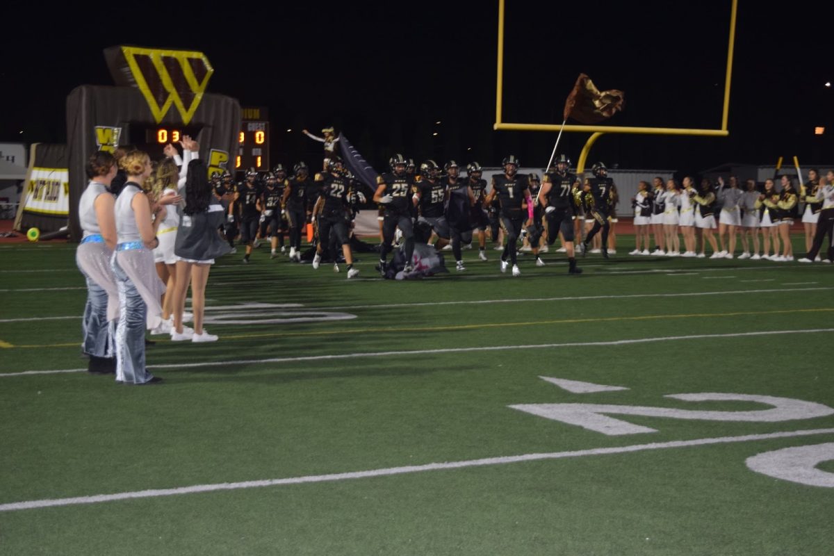 On Friday, Oct. 20, 2023, the West High Warriors prepare to compete in their Homecoming game against the Torrance High Tartars. Despite a 13–30 loss, the football team received unwavering support from the student section and entertainment units. Photo courtesy of Christine Huston.