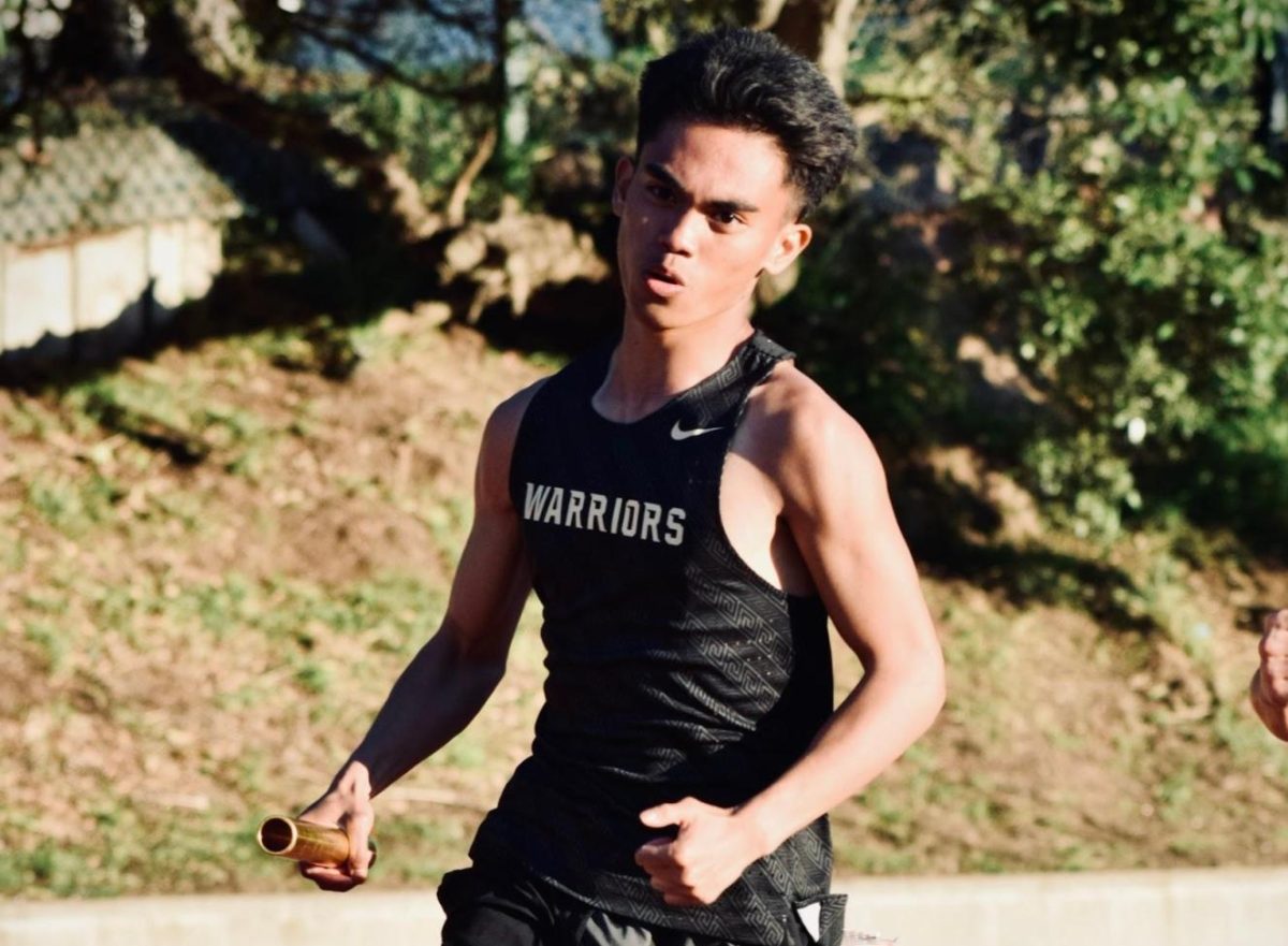 Aerel J Gapusan (12) sprints down the final stretch during the Mustang Relay. He pushed through his last few meters as teammates cheered from the sidelines.