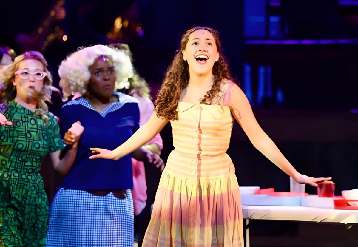 Camilla Guzman (10) as Sandy Debrowski sings “Summer Nights,” one of the many popular songs from Grease.  
